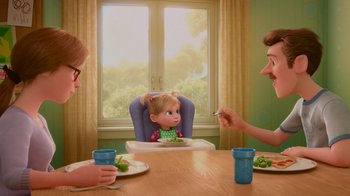 Movie still from “Inside Out” (2015), directed by Pete Docter – Two adults and a child sitting at a table with a plate of food in front of them; Medium shot, Over the shoulder angle