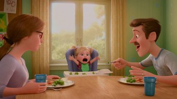 Movie still from “Inside Out” (2015), directed by Pete Docter – Two adults and a child sitting at a table with broccoli in front of a window; Wide shot, Over the shoulder angle