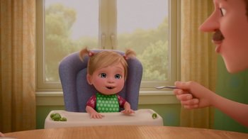 Movie still from “Inside Out” (2015), directed by Pete Docter – A person is feeding a baby in a high chair; Medium shot, Over the shoulder angle