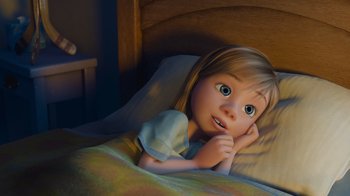 Movie still from “Inside Out” (2015), directed by Pete Docter – A little girl laying in a bed with her hand under her chin; Medium shot, High angle