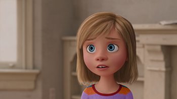 Movie still from “Inside Out” (2015), directed by Pete Docter – A cartoon girl with brown hair and blue eyes looking up; Close Up shot, Over the shoulder angle