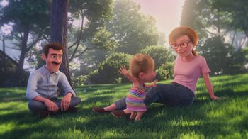 Movie still from “Inside Out” (2015), directed by Pete Docter – An animated family sitting in the grass together; Wide shot, Over the shoulder angle