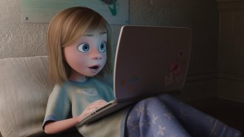 Movie still from “Inside Out” (2015), directed by Pete Docter – A little girl sitting on the ground with a laptop; Medium shot, Overhead angle
