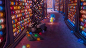 Movie still from “Inside Out” (2015), directed by Pete Docter – A person walking down a street near a pile of donuts; Extreme Wide shot, High angle