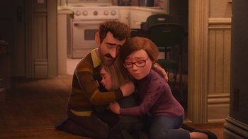 Movie still from “Inside Out” (2015), directed by Pete Docter – A couple of people sitting on the floor hugging each other; Medium shot, High angle