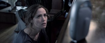 Movie still from “Insidious” (2010), directed by James Wan – A woman sitting in front of a piano looking into the mirror; Close Up shot, High angle