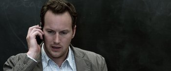 Movie still from “Insidious” (2010), directed by James Wan – A person wearing a jacket; Close Up shot, Over the shoulder angle