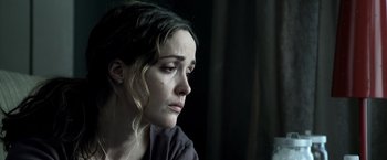 Movie still from “Insidious” (2010), directed by James Wan – A person sitting in a room; Close Up shot, Over the shoulder angle