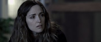 Movie still from “Insidious” (2010), directed by James Wan – A person with long brown hair; Close Up shot, Over the shoulder angle