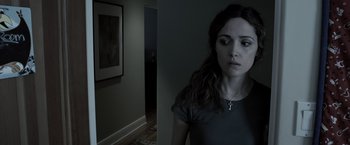 Movie still from “Insidious” (2010), directed by James Wan – A woman standing next to a wall in a dark room; Close Up shot, Over the shoulder angle