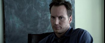 Movie still from “Insidious” (2010), directed by James Wan – A person sitting on a couch; Close Up shot, High angle