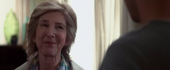 Movie still from “Insidious” (2010), directed by James Wan – An older woman is smiling at the camera; Close Up shot, Over the shoulder angle
