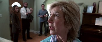 Movie still from “Insidious” (2010), directed by James Wan – An older woman is looking up at the camera; Close Up shot, Over the shoulder angle