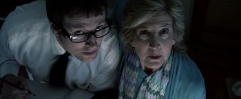 Movie still from “Insidious” (2010), directed by James Wan – A man and a woman looking at a computer screen; Close Up shot, Low angle