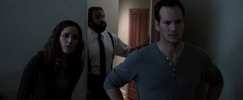 Movie still from “Insidious” (2010), directed by James Wan – A man and a woman in a room with a mirror; Medium shot, Over the shoulder angle