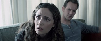 Movie still from “Insidious” (2010), directed by James Wan – A woman and a man are looking at the camera; Close Up shot, Over the shoulder angle