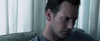 Movie still from “Insidious” (2010), directed by James Wan – A person's face on a couch; Close Up shot, Low angle