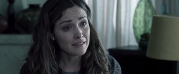 Movie still from “Insidious” (2010), directed by James Wan – A person with a crying face; Close Up shot, Over the shoulder angle