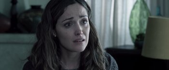 Movie still from “Insidious” (2010), directed by James Wan – A person with a crying face; Close Up shot, Over the shoulder angle