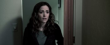 Movie still from “Insidious” (2010), directed by James Wan – A woman with long brown curly hair looking at the camera; Close Up shot, Over the shoulder angle