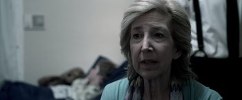 Movie still from “Insidious” (2010), directed by James Wan – An older woman is looking at the camera; Close Up shot, Over the shoulder angle