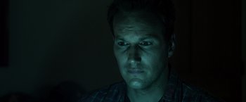 Movie still from “Insidious” (2010), directed by James Wan – A person looking at the camera; Close Up shot, Low angle