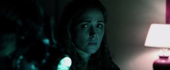 Movie still from “Insidious” (2010), directed by James Wan – A person holding a flashlight; Close Up shot, Over the shoulder angle