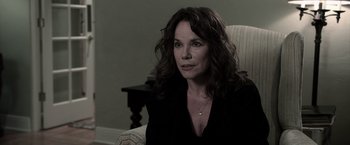 Movie still from “Insidious” (2010), directed by James Wan – A person sitting in a chair; Close Up shot, Over the shoulder angle