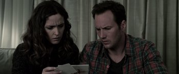 Movie still from “Insidious” (2010), directed by James Wan – A man and a woman looking at a piece of paper; Close Up shot, High angle