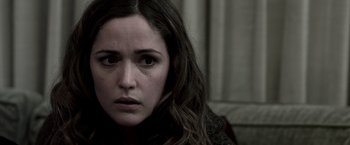 Movie still from “Insidious” (2010), directed by James Wan – A person with long brown hair; Close Up shot, Over the shoulder angle