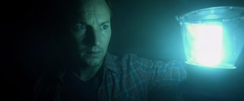 Movie still from “Insidious” (2010), directed by James Wan – A person in a dark room; Close Up shot, Low angle