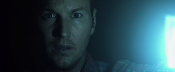 Movie still from “Insidious” (2010), directed by James Wan – A person's face in a dark room; Close Up shot, Over the shoulder angle