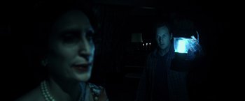 Movie still from “Insidious” (2010), directed by James Wan – A man and a woman in a dark room; Close Up shot, Over the shoulder angle