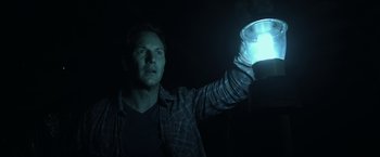 Movie still from “Insidious” (2010), directed by James Wan – A man holding a jar in a dark room; Close Up shot, Low angle