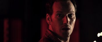 Movie still from “Insidious” (2010), directed by James Wan – A person wearing a plaid shirt; Close Up shot, Low angle