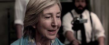 Movie still from “Insidious” (2010), directed by James Wan – An older woman is looking into the distance; Close Up shot, Over the shoulder angle