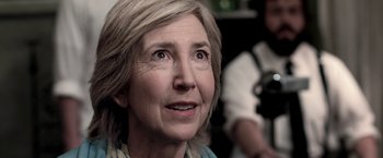 Movie still from “Insidious” (2010), directed by James Wan – An older woman looking up at the camera; Close Up shot, Over the shoulder angle