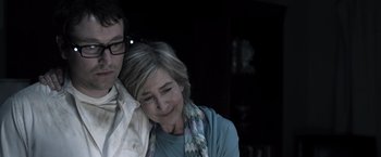 Movie still from “Insidious” (2010), directed by James Wan – An older woman sitting next to a younger man; Close Up shot, Low angle
