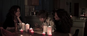 Movie still from “Insidious” (2010), directed by James Wan – A woman and a child eating a bowl of food; Medium shot, High angle