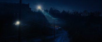 Movie still from “Insidious: The Last Key” (2018), directed by Adam Robitel – A car driving down a road at night with a light shining on it; Extreme Wide shot, High angle
