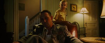 Movie still from “Insidious: The Last Key” (2018), directed by Adam Robitel – A man and a boy are sitting in a chair; Medium shot, Low angle