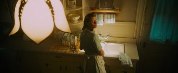 Movie still from “Insidious: The Last Key” (2018), directed by Adam Robitel – A woman standing in a kitchen next to a sink; Medium shot, Low angle