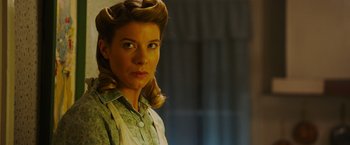 Movie still from “Insidious: The Last Key” (2018), directed by Adam Robitel – A woman in a green shirt with a blonde hair style; Close Up shot, Low angle