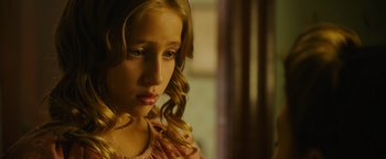 Movie still from “Insidious: The Last Key” (2018), directed by Adam Robitel – A young girl with long blonde hair looking to her left; Close Up shot, Over the shoulder angle