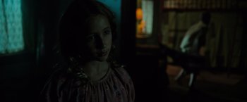 Movie still from “Insidious: The Last Key” (2018), directed by Adam Robitel – A young girl is standing in a dark room; Close Up shot, Over the shoulder angle