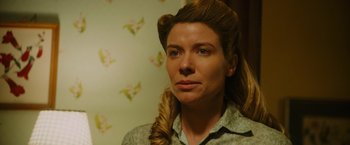 Movie still from “Insidious: The Last Key” (2018), directed by Adam Robitel – A person wearing a shirt; Close Up shot, Over the shoulder angle