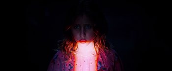 Movie still from “Insidious: The Last Key” (2018), directed by Adam Robitel – A young girl is glowing in the dark; Close Up shot, High angle