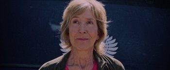 Movie still from “Insidious: The Last Key” (2018), directed by Adam Robitel – An older woman is smiling for the camera; Close Up shot, Low angle