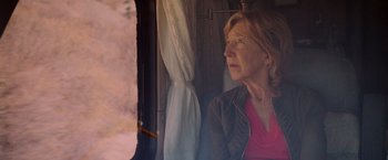 Movie still from “Insidious: The Last Key” (2018), directed by Adam Robitel – A woman sitting on a train looking out the window; Close Up shot, Over the shoulder angle