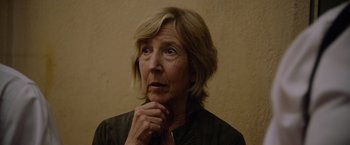 Movie still from “Insidious: The Last Key” (2018), directed by Adam Robitel – An older woman is looking at the camera with her hand on her chin; Close Up shot, Low angle